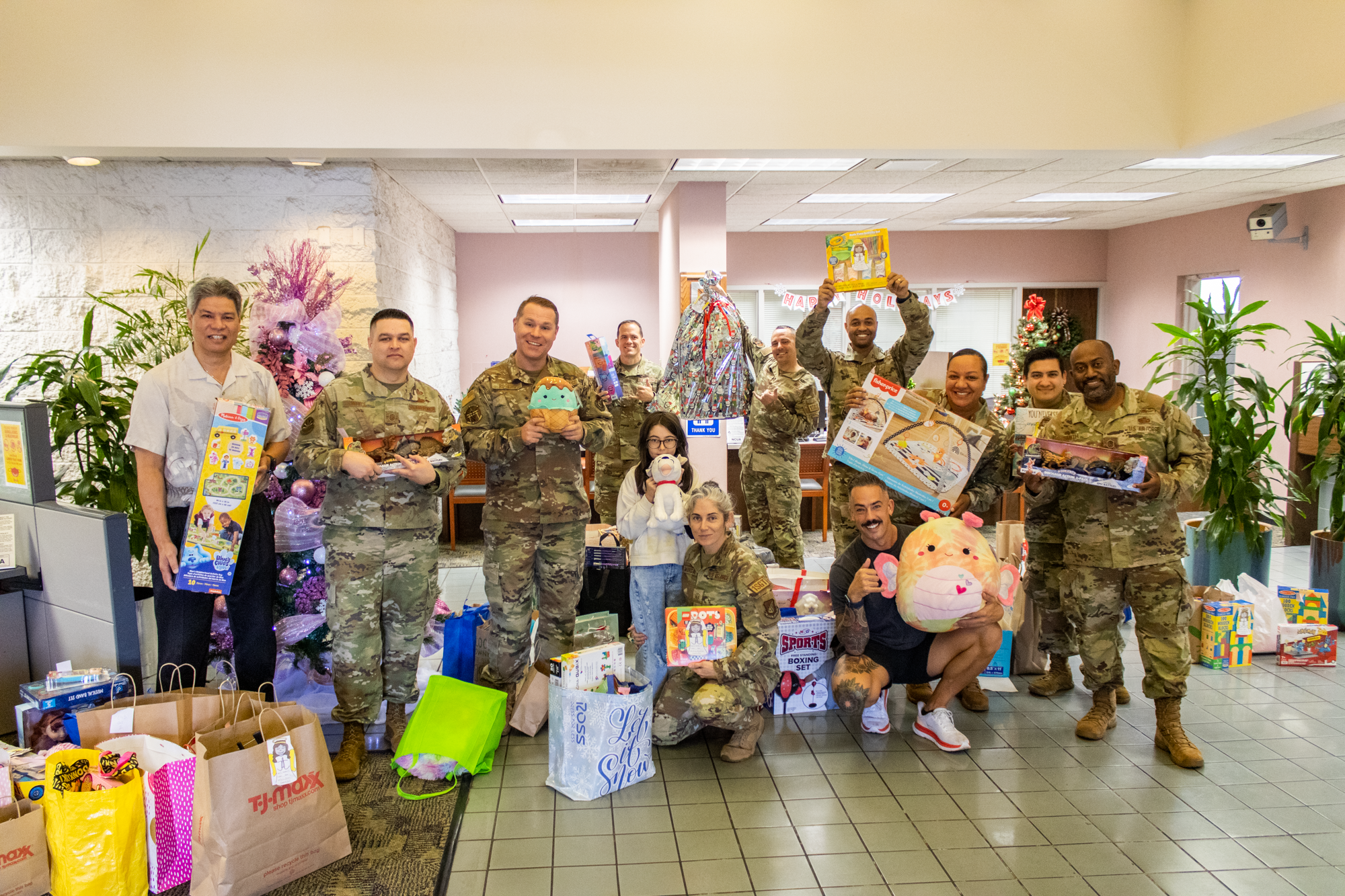 Scott Kaulukukui, Hickam FCU President/CEO poses with the Hawaii Air Force First Sergeants for Angel Tree